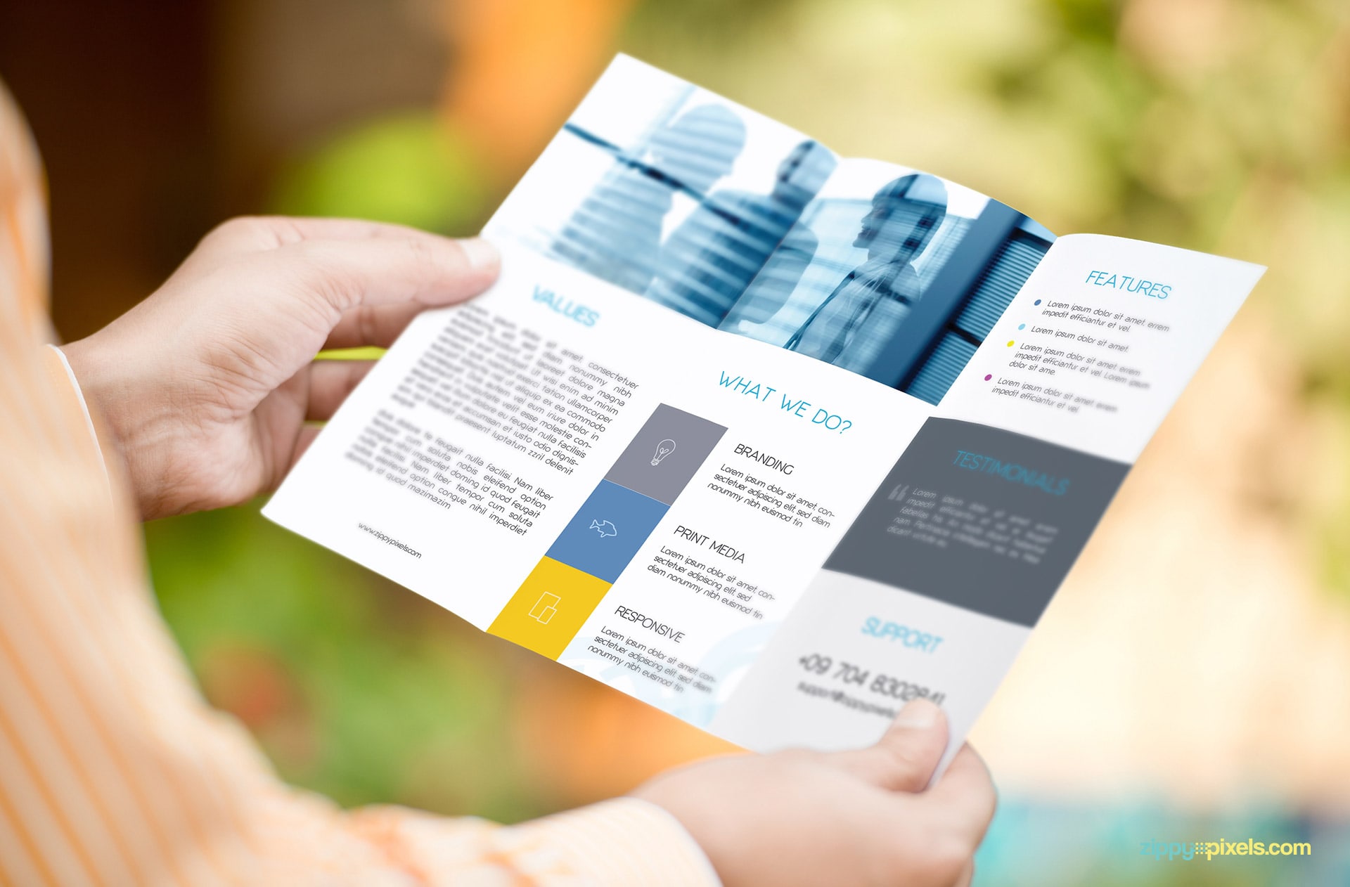 Mockup of Trifold Flyer Held in Both Hands