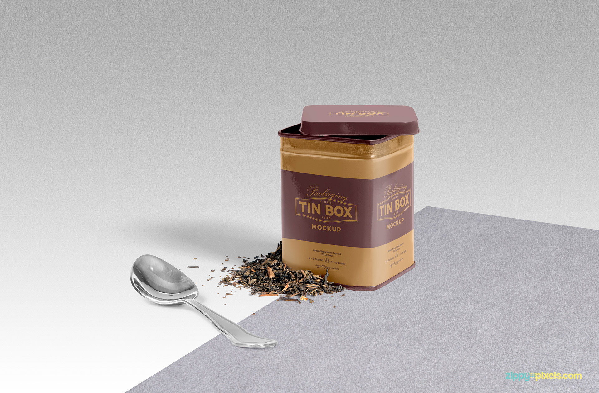 Vintage style tin box mockup with spoon and tea leaves on surface