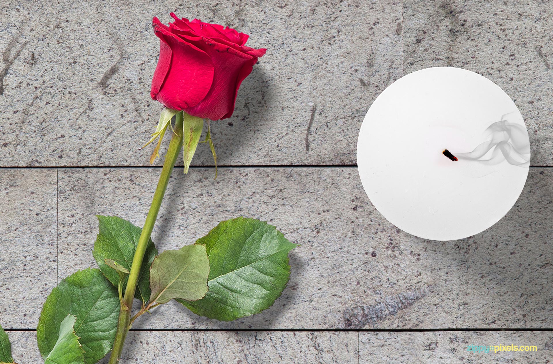 Beautiful red rose placed beside the candle.